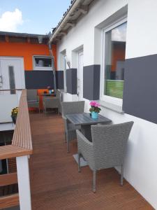 a patio with a table and chairs on a balcony at Mara in Lübeck