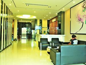 a man sitting in a waiting room at a hospital at 7Days Premium Huizhou Boluo Lake Town Luofushan in Huizhou