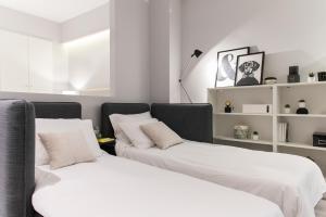 two beds sitting next to each other in a room at JB Luxury Suites in Nafplio