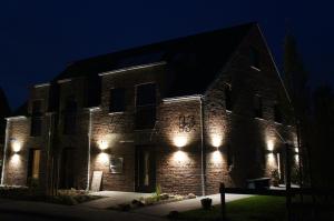 a brick building with lights on it at night at Bisping33 - Beletage in Ascheberg