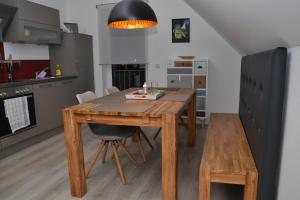 a kitchen with a wooden table and a dining room at Bisping33 - Beletage in Ascheberg