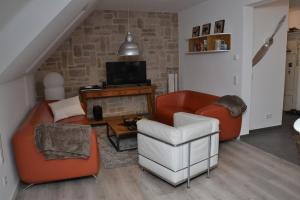 a living room with two chairs and a television at Bisping33 - Beletage in Ascheberg