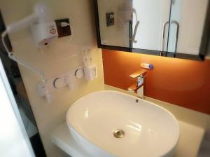 a bathroom with a white toilet and a mirror at 7Days Premium Shizuishan Dawukou in Shizuishan +16 photos