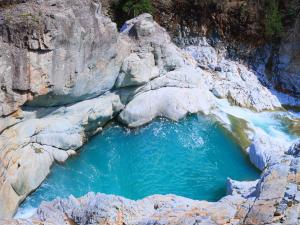 a large pool of blue water in a rocky canyon at Kinugawa Onsen Hana no Yado Matsuya in Nikko