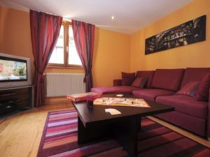 a living room with a couch and a coffee table at La Maison Bleue in Kientzheim