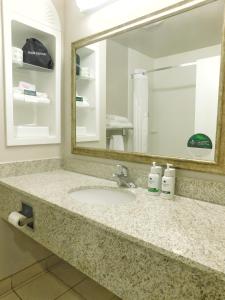 a bathroom counter with a sink and a mirror at GreenTree Inn & Suites Pinetop in Pinetop-Lakeside