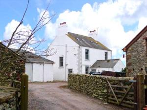 a white house with a fence in front of it at Raceside Farm in Silecroft