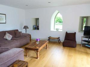 a living room with a couch and a coffee table at Muirmailing Cottage in Plean