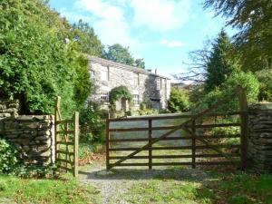 a wooden fence in front of a house at High Kiln Bank Cottage in Ulpha