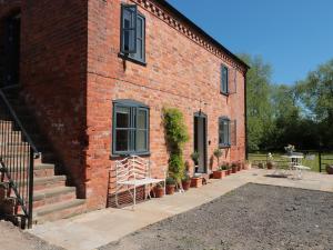 a brick building with stairs and plants on it at Granary 1 in Hereford