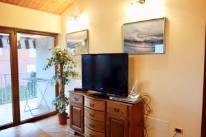 a flat screen tv sitting on top of a wooden dresser at Apartment Marina in Medulin