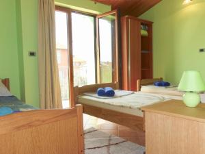 a bedroom with two beds and a window at Apartment Marina in Medulin