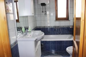 a bathroom with a sink and a tub and a toilet at Apartment Marina in Medulin