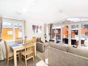 a living room with a couch and a table at 32 Cruachan Lodge in Auchterarder