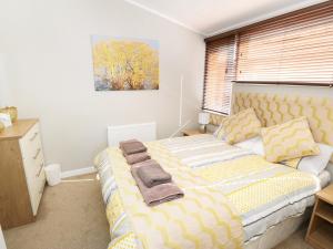 a bedroom with a bed with towels on it at 32 Cruachan Lodge in Auchterarder