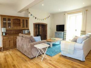 a living room with a couch and a table at East Wing in Crewkerne