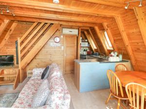 a living room with a couch and a table in a cabin at Apple Tree Lodge in Gillingham