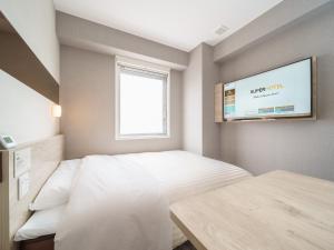 Postel nebo postele na pokoji v ubytování Super Hotel Saitama Kawagoe