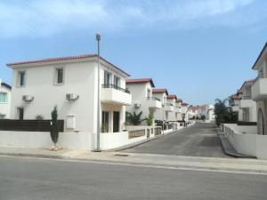a row of white houses on a street at Luxury Villa Private Pool and Wifi Perfect location for a holiday in Protaras