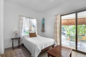 a bedroom with a bed and a sliding glass door at Villas Akalan in Tulum +117 photos