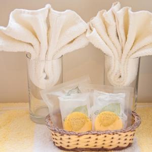 a basket of lemons next to a glass of water at Down Ende House Accommodation in Looe