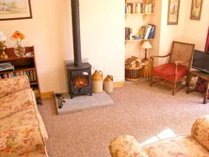 a living room with a wood stove in a room at The Cygnet in Haselbury Plucknett