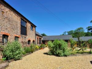 an old brick building with bushes in front of it at Rainsbury House in Taunton