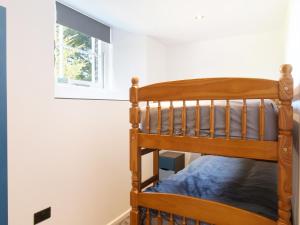 a wooden bunk bed in a room with a window at Moor View Chapel in Camelford