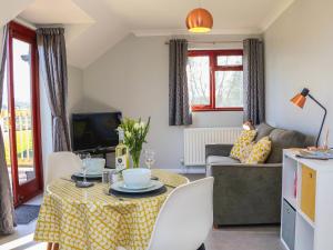 a living room with a table and a couch at Little Acorn in Barnstaple