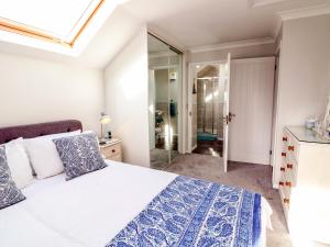 a bedroom with a bed and a glass shower at Little Acorn in Barnstaple