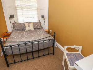 a bedroom with a bed and a window at Apartment 3 in Tenby