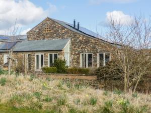 a stone house in the middle of a field at Beckside in Cockermouth