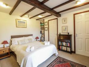 a bedroom with a large bed with towels on it at Brunnion House in Hayle