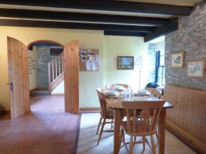 a dining room with a wooden table and chairs at Old Winery Cottage in Golant