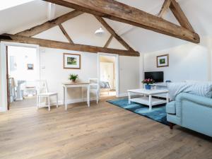 a living room with a blue couch and a table at Granary 2 in Hereford