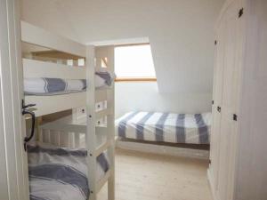 a room with two bunk beds and a window at Isallt Lodge in Holyhead