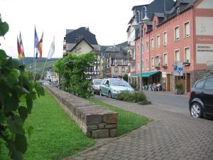 a street in a town with cars parked on the street at Haus Marlene in Zell an der Mosel