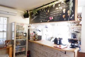 a coffee shop with a chalkboard on the wall at IZA Enoshima Guest House and Bar in Fujisawa