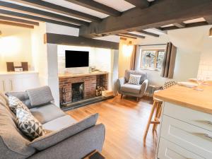 a living room with a couch and a fireplace at 4 Masons Court in Stratford-upon-Avon