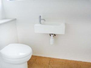 a bathroom with a white toilet and a sink at 6 Knott in Flashader +11 photos