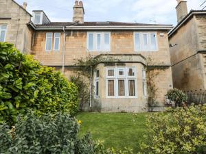 an old brick house with a yard in front of it at 33 Crescent Gardens in Bath