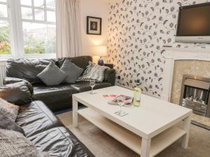 a living room with a couch and a table at Quarterdeck in Scarborough +5 photos