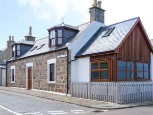 a building on a street with a building with a roof at Seascape in Buckie