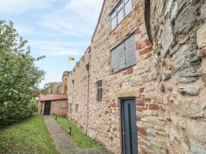 an old brick building with a door in the side of it at Castle House in Taunton