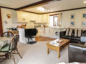 a living room with a couch and a table at Brunnion Cottage in Hayle