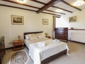 a bedroom with two beds and a dresser at Brunnion Cottage in Hayle