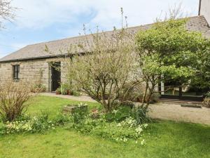 a stone house with a garden in front of it at Brunnion Cottage in Hayle