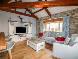 a living room with a couch and a tv at Argal in Penryn