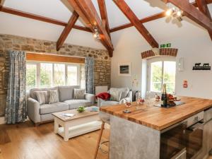 a kitchen and living room with wooden ceilings at Argal in Penryn