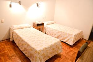 Postel nebo postele na pokoji v ubytování Hotel Los Cedros